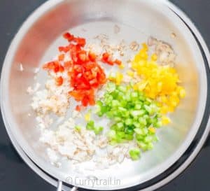 3 colored bell peppers in pan for cooking quinoa stuffed butternut squash