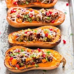 Stuffed butternut squash with quinoa arranged on baking tray