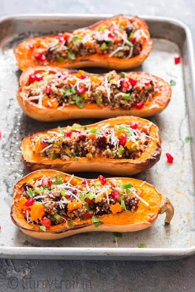 Stuffed butternut squash with quinoa arranged on baking tray