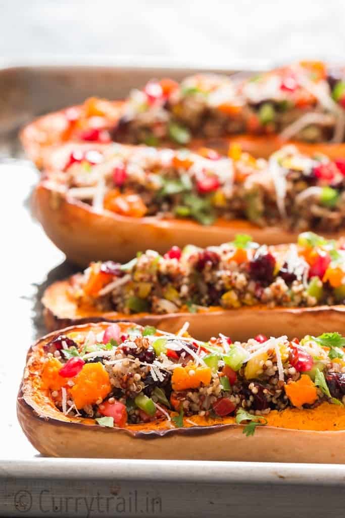 Stuffed butternut squash with quinoa arranged on baking tray