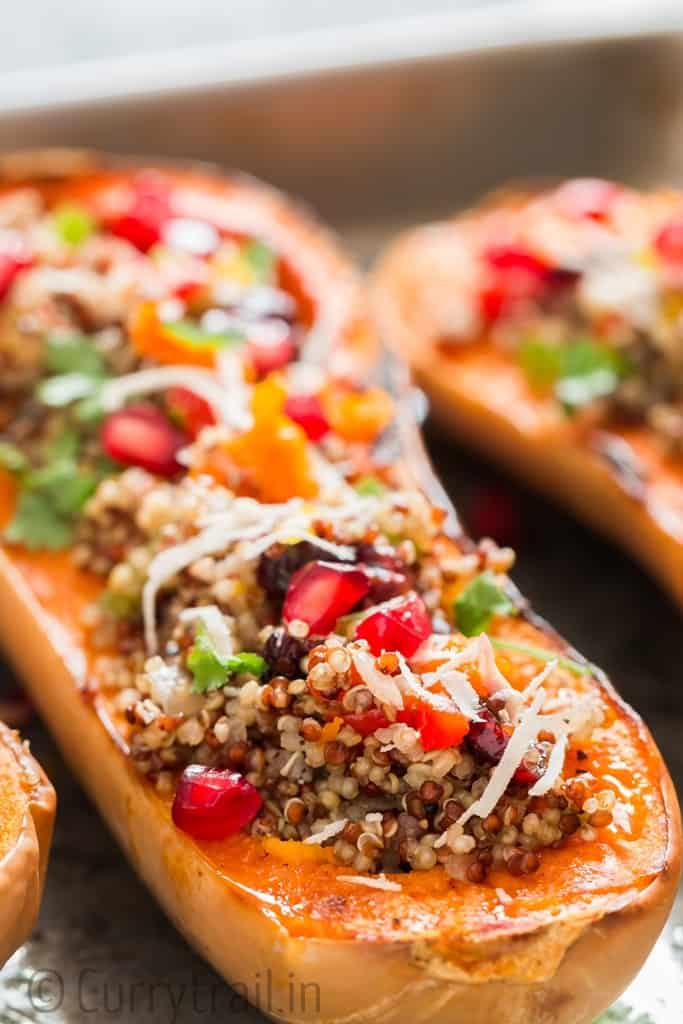 Stuffed butternut squash with quinoa arranged on baking tray