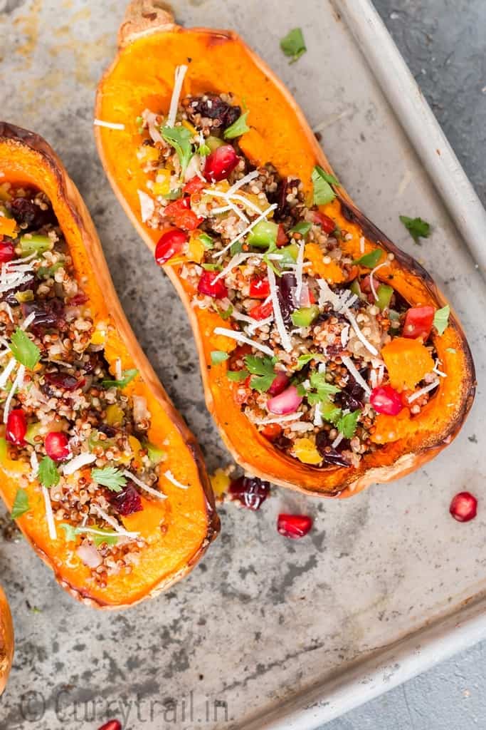 Stuffed butternut squash with quinoa arranged on baking tray