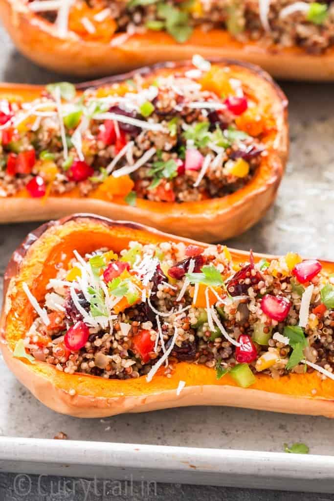 Stuffed butternut squash with quinoa arranged on baking tray