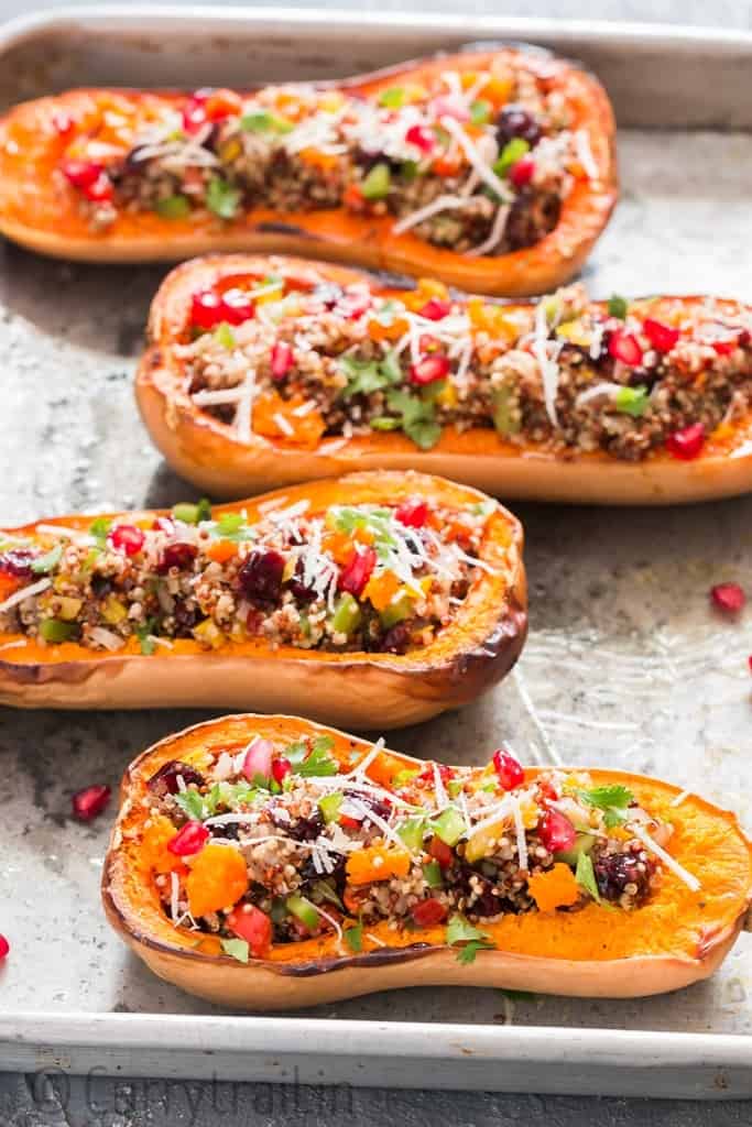 Stuffed butternut squash with quinoa arranged on baking tray