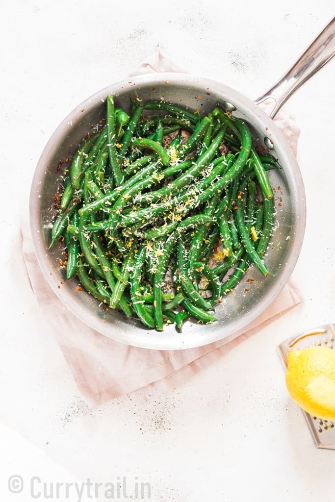 garlic sauteed green beans sprinkled with Parmesan and lemon zest served in skillet