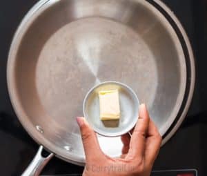 Saute green beans in butter in skillet