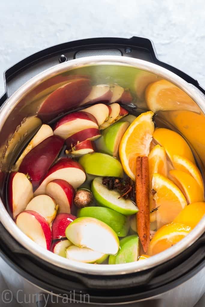 Ingredients added to instant pot for apple cider recipe