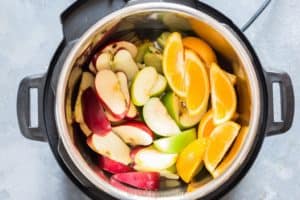 Ingredients added to instant pot for apple cider recipe