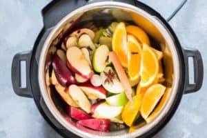 Ingredients added to instant pot for apple cider recipe