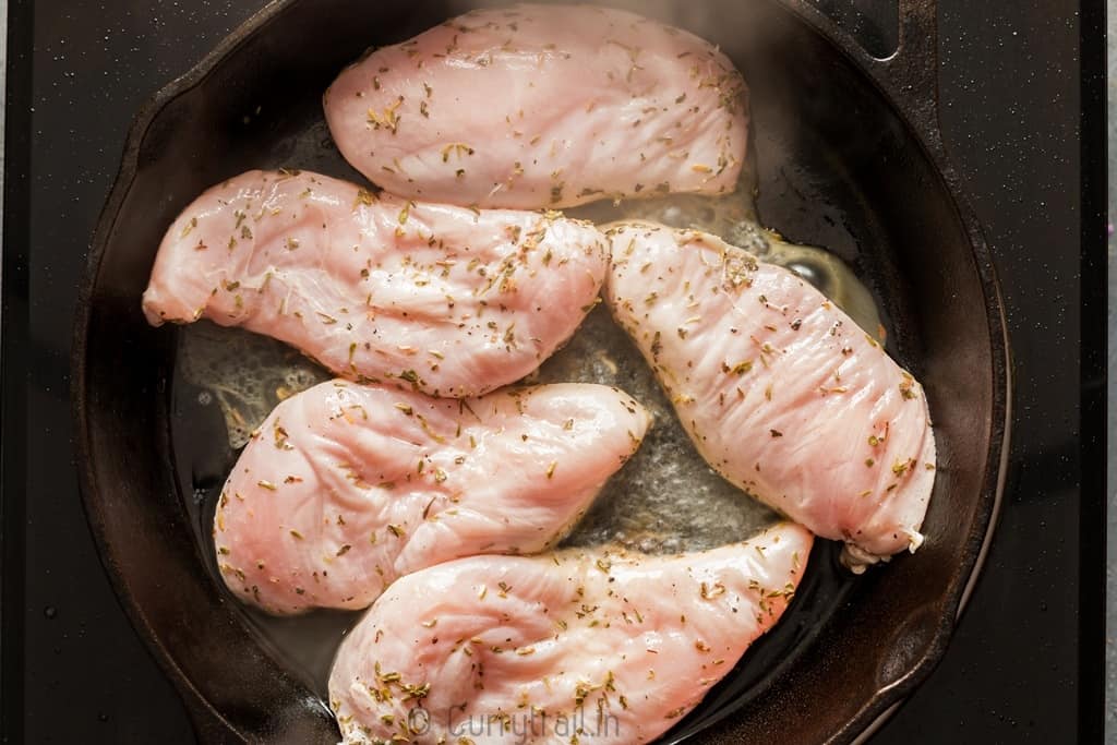 Marinated lemon chicken on cast iron pan