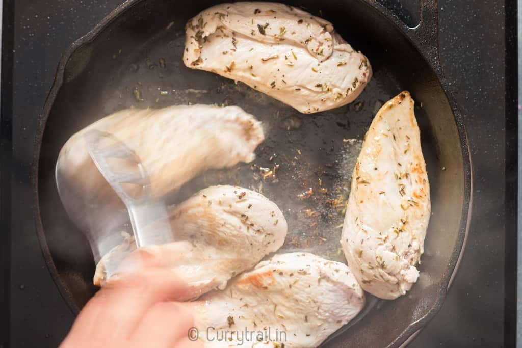 Marinated lemon chicken on cast iron pan