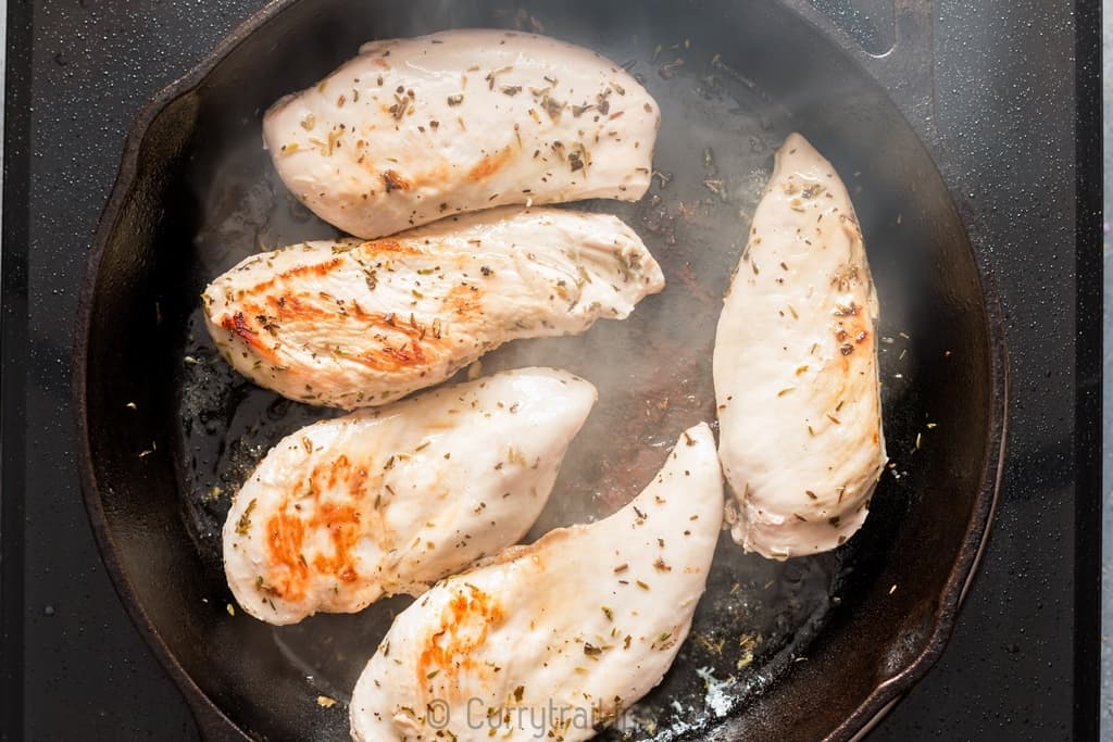 Marinated lemon chicken on cast iron pan