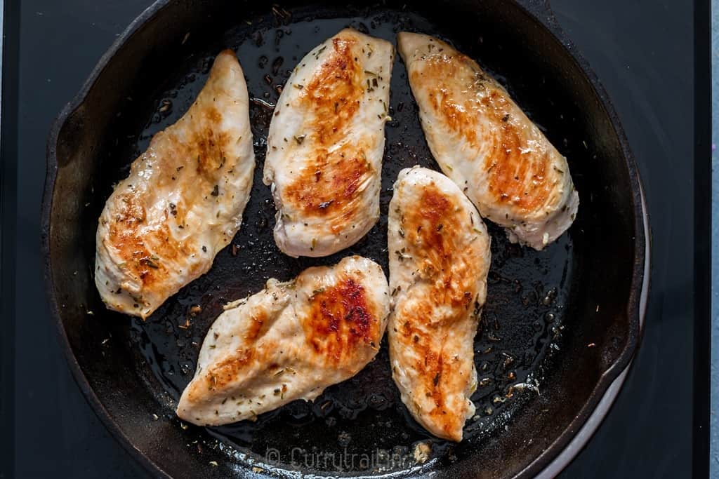 Marinated lemon chicken on cast iron pan