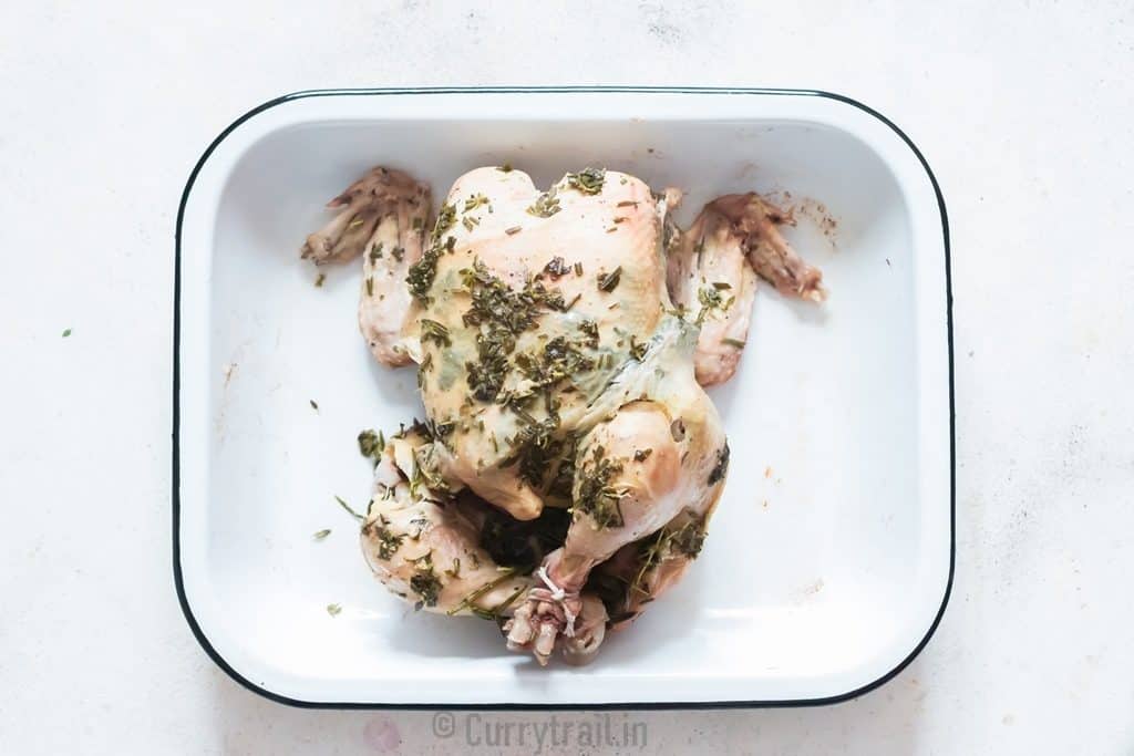 pressure-cooked whole chicken placed on a white tray.