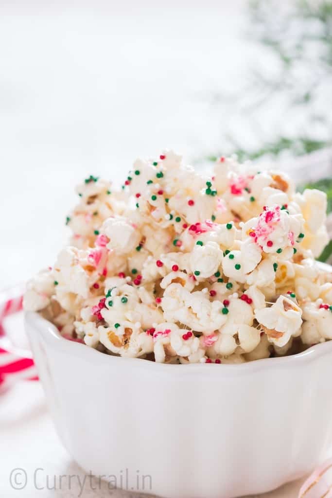Christmas popcorn snack mix in ceramic bowl