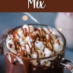 hot chocolate in a glass cup topped with mini marshmallows with text overlay.