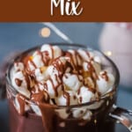 hot chocolate in a glass cup topped with mini marshmallows with text overlay.