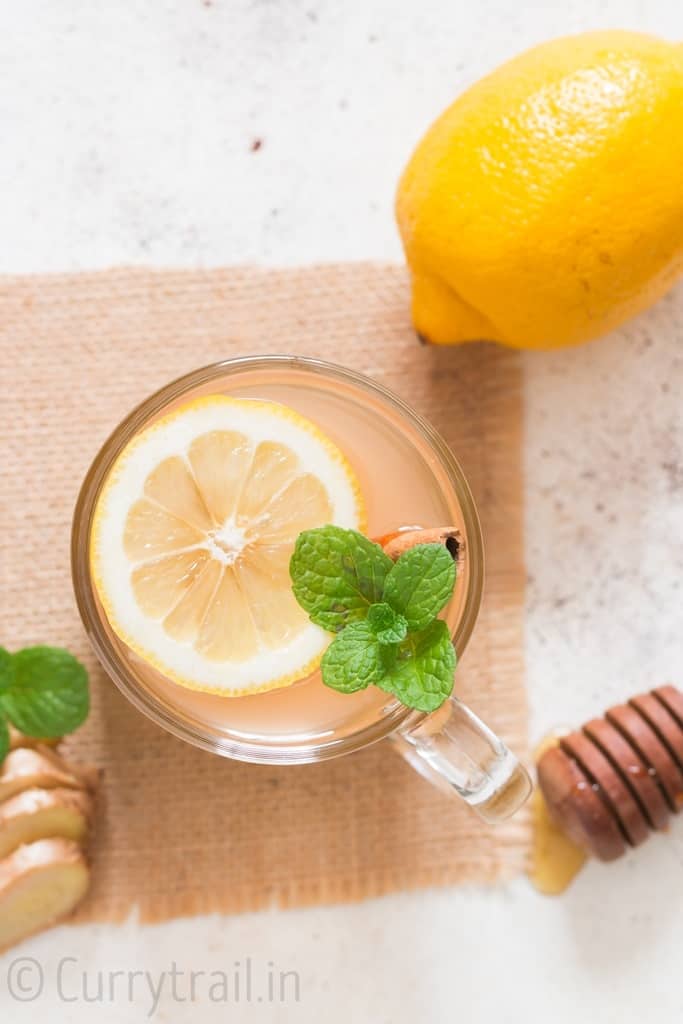 honey lemon ginger tea served in glass mug is soothing and refreshing drink that helps you fight cold and flu. It helps detox and calm you down during stress