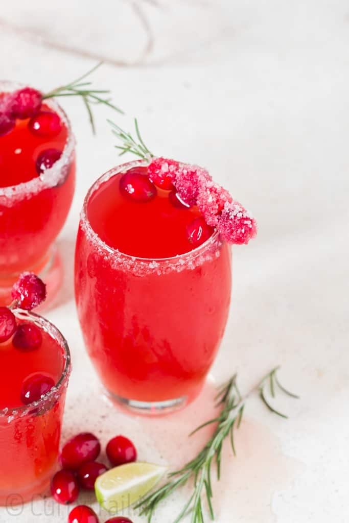 cranberry margaritas in 3 serving glasses