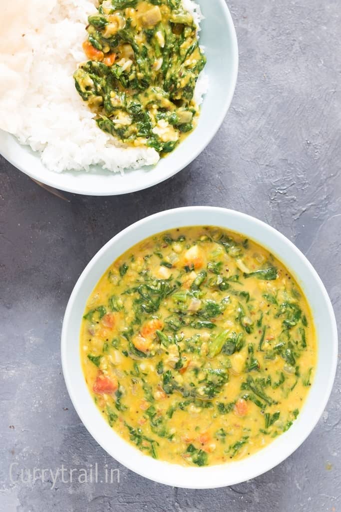 dal palak served with rice in two bowls