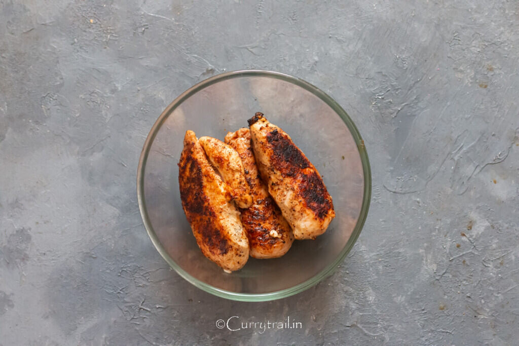 brown seared chicken breasts in a bowl.