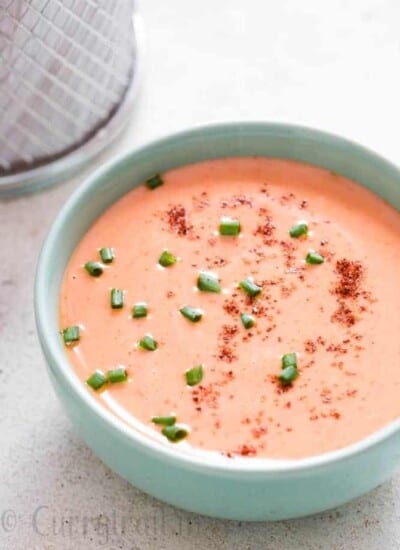bang bang shrimp sauce in bowl with fried shrimps on side