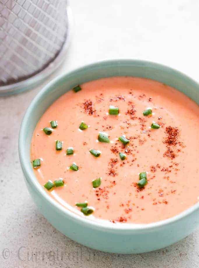 bang bang shrimp sauce in bowl with fried shrimps on side