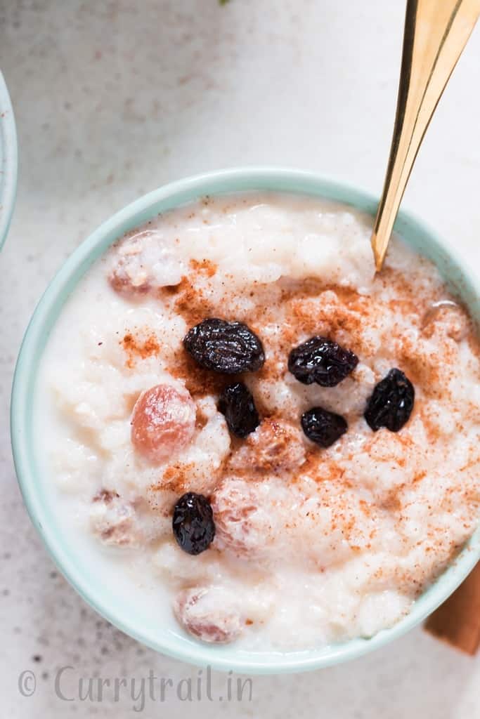 instant pot rice pudding served in ceramic bowl with raisins on top