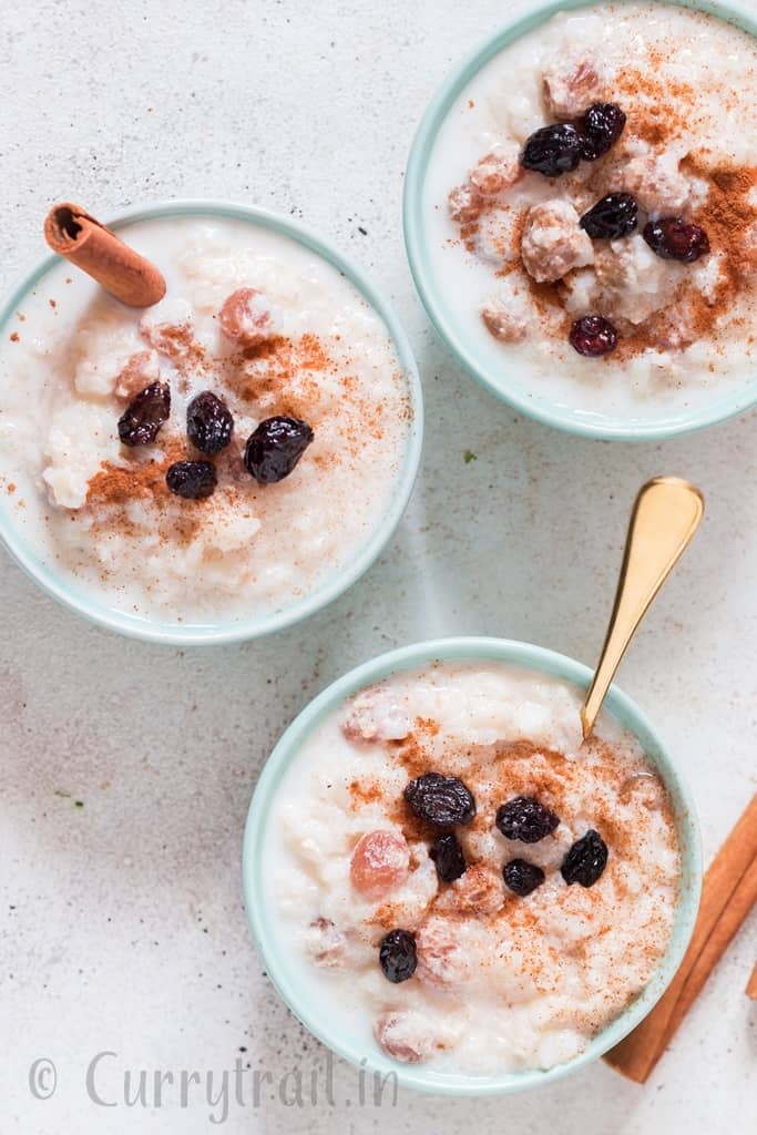 instant pot rice pudding served in ceramic bowl with raisins on top