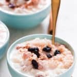 instant pot rice pudding served in ceramic bowl with raisins on top