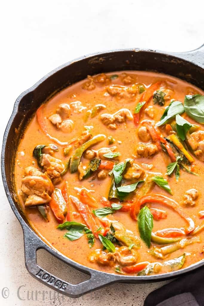 best Thai chicken Panang curry topped with fresh basil cooked in cast iron pan