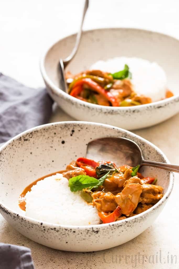 best Thai chicken Panang curry served with steamed rice in white ceramic bowl