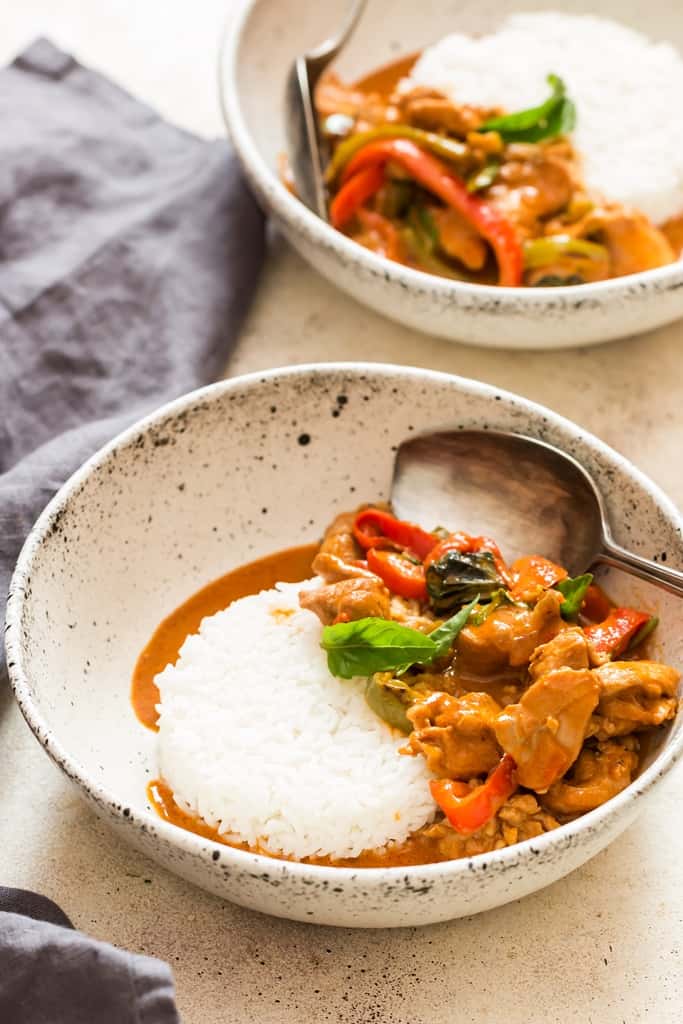 best Thai chicken Panang curry served with steamed rice in white ceramic bowl