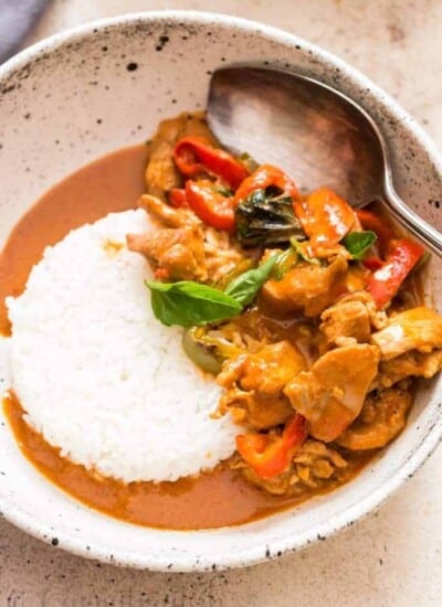 best Thai chicken Panang curry served with steamed rice in white ceramic bowl