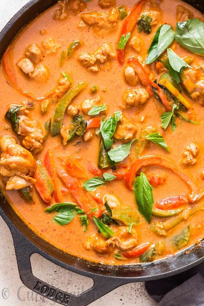 best Thai chicken Panang curry topped with fresh basil cooked in cast iron pan