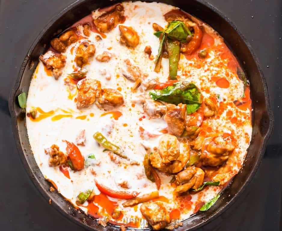 Thai curry cooked in coconut milk in a skillet.