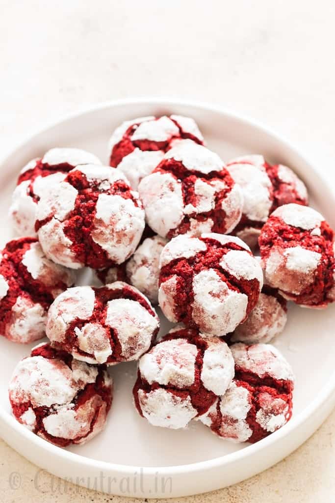 red velvet crinkle cookies lined on white plate