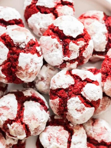 red velvet crinkle cookies lined on white plate