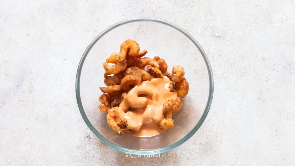 crispy fried shrimp with bang bang sauce in a bowl.