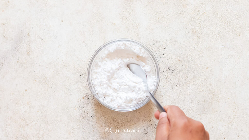 cornstarch mixed with garlic powder, salt, and pepper in a bowl.