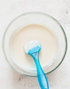 melted white chocolate with coconut oil in microwave bowl