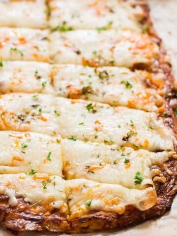 cheesy cauliflower breadsticks served with spicy marinara sauce