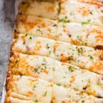 cheesy cauliflower breadsticks served with spicy marinara sauce with text overlay