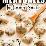 juicy chicken meatballs in white sauce in cast iron pan with text