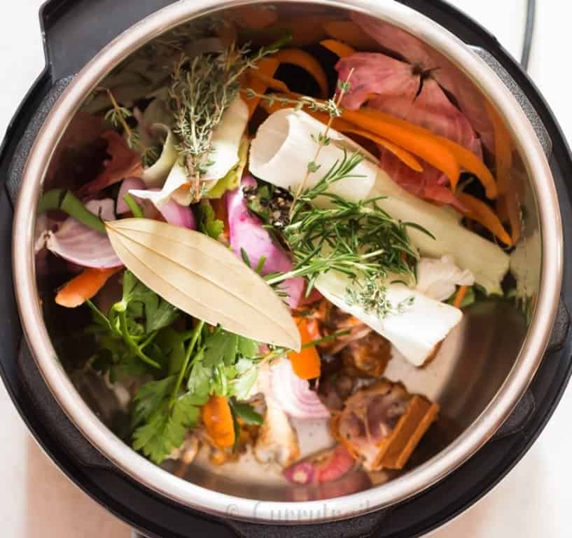 instant pot bone broth in the making, chicken bones, vegetables scraped added inside the pot