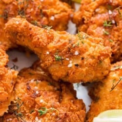 ultimate ultra crispy and moist Southern fried chicken with lemon wedges