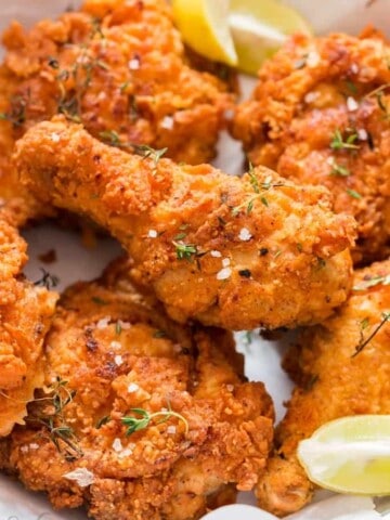 ultimate ultra crispy and moist Southern fried chicken with lemon wedges