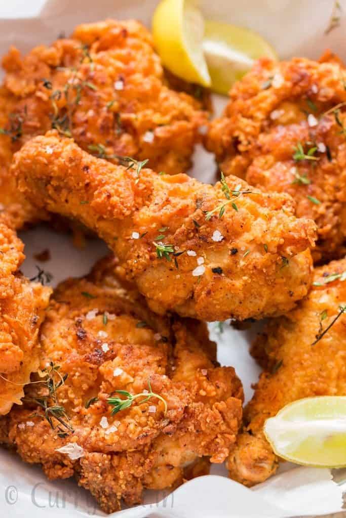 ultimate ultra crispy and moist Southern fried chicken with lemon wedges