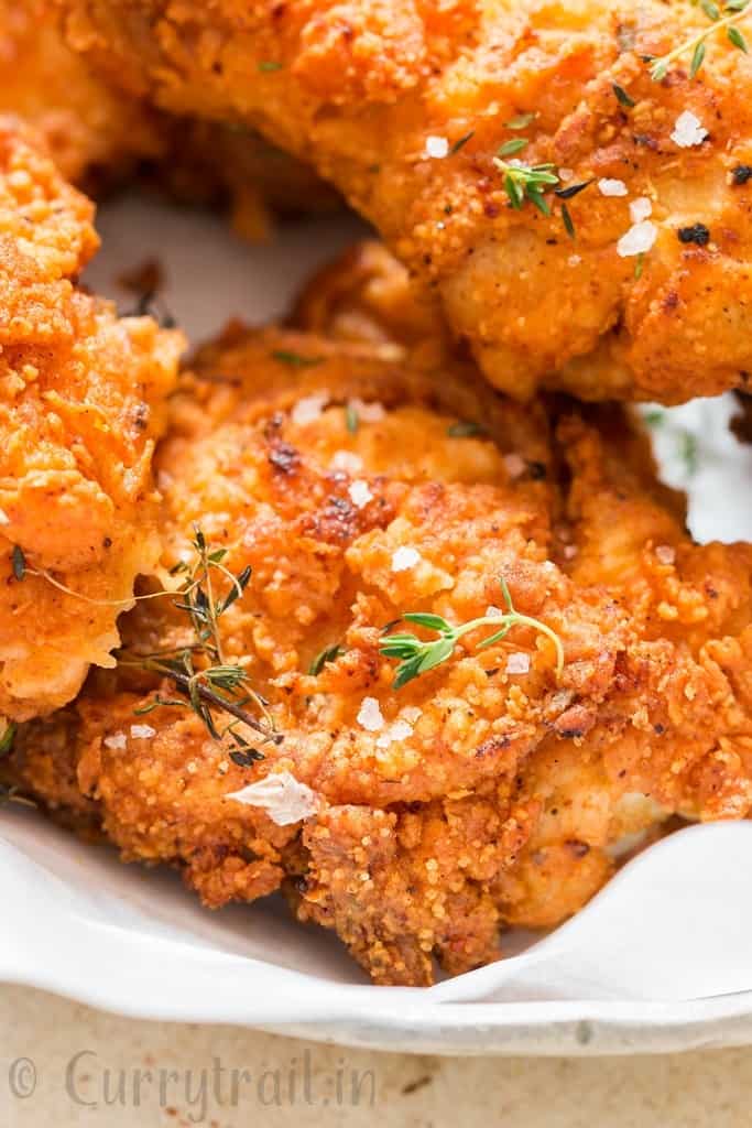 ultimate ultra crispy and moist Southern fried chicken with lemon wedges