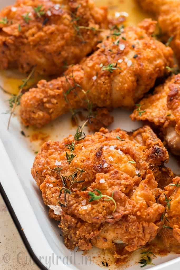 ultimate ultra crispy and moist Southern fried chicken with lemon wedges